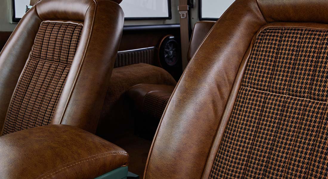 Brown leather and patterned fabric seats inside a Classic Ford Bronco