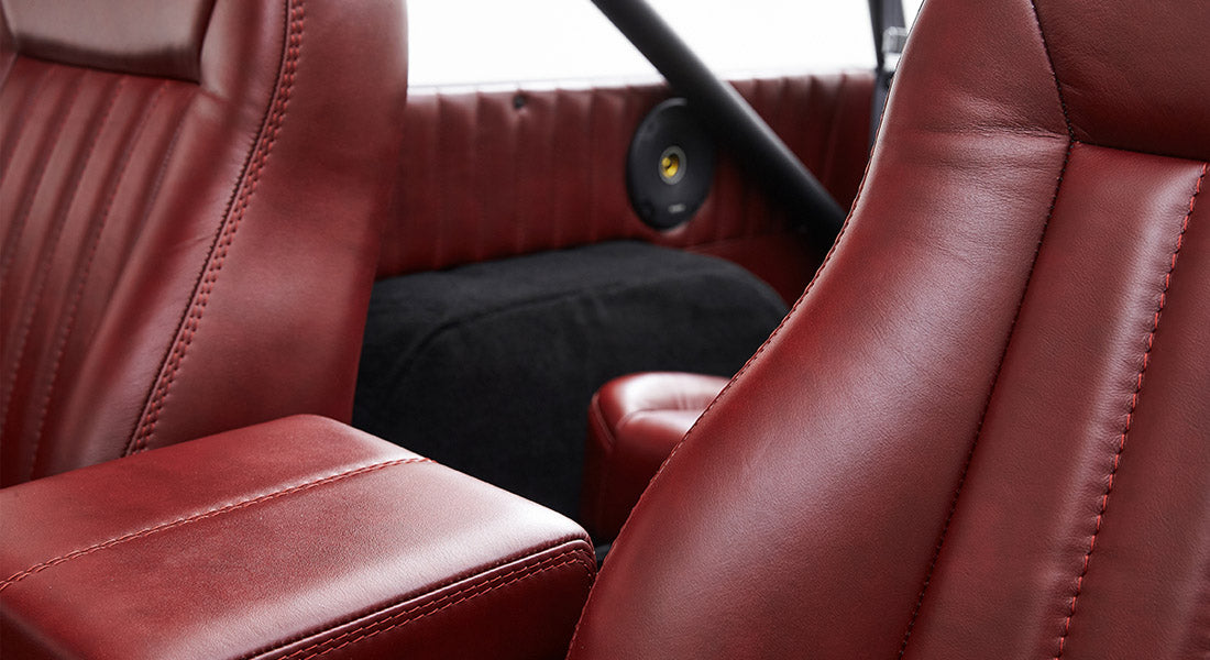 Red leather seats with stitching detail in Classic Ford Bronco interior