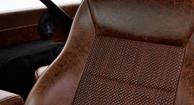 Close-up of textured brown leather seat with woven pattern in Classic Ford Bronco interior