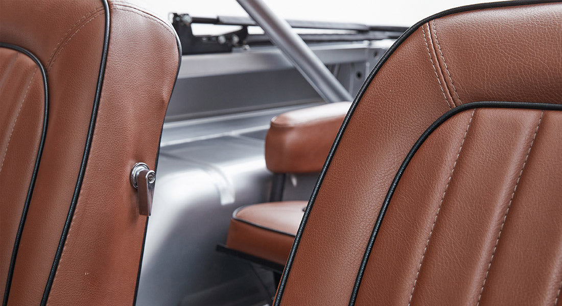 Rear leather seats in Classic Ford Bronco in brown upholstery with gray metal interior