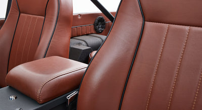Brown leather seats and center armrest inside Classic Ford Bronco