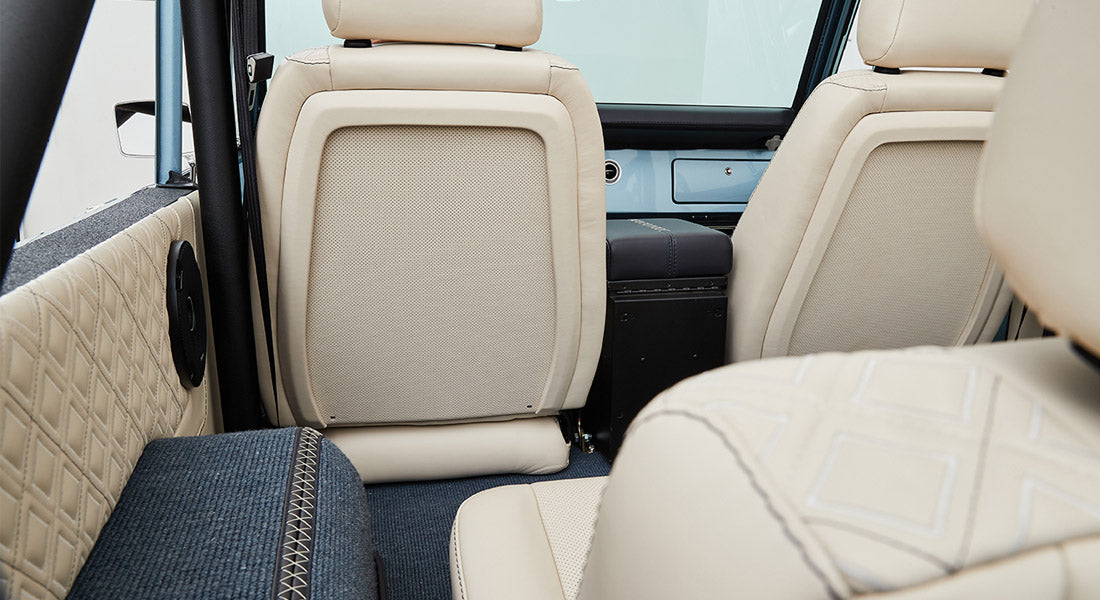 Rear seatback and quilted beige door panel inside a Classic Ford Bronco