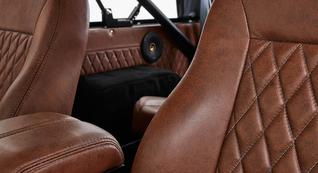 Brown leather seats with diamond stitching and speaker inside Classic Ford Bronco interior
