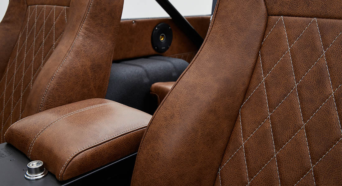 Brown leather front seats with diamond stitching and armrest inside Classic Ford Bronco