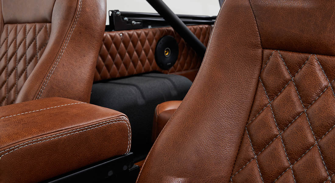 Close-up of brown leather seats with diamond stitching inside a Classic Ford Bronco