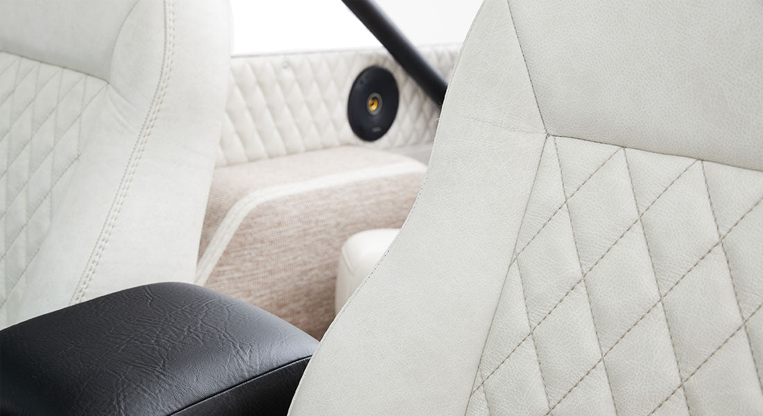 White diamond-stitched upholstery seats and door panel interior of Classic Ford Bronco