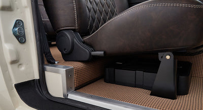 Carpeted floor and side trim under a seat inside a Classic Ford Bronco