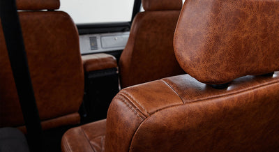 Interior view of Classic Ford Bronco with tan leather seats and headrest stitching