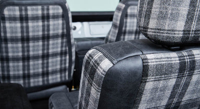 Plaid fabric and leather front seats inside a Classic Ford Bronco