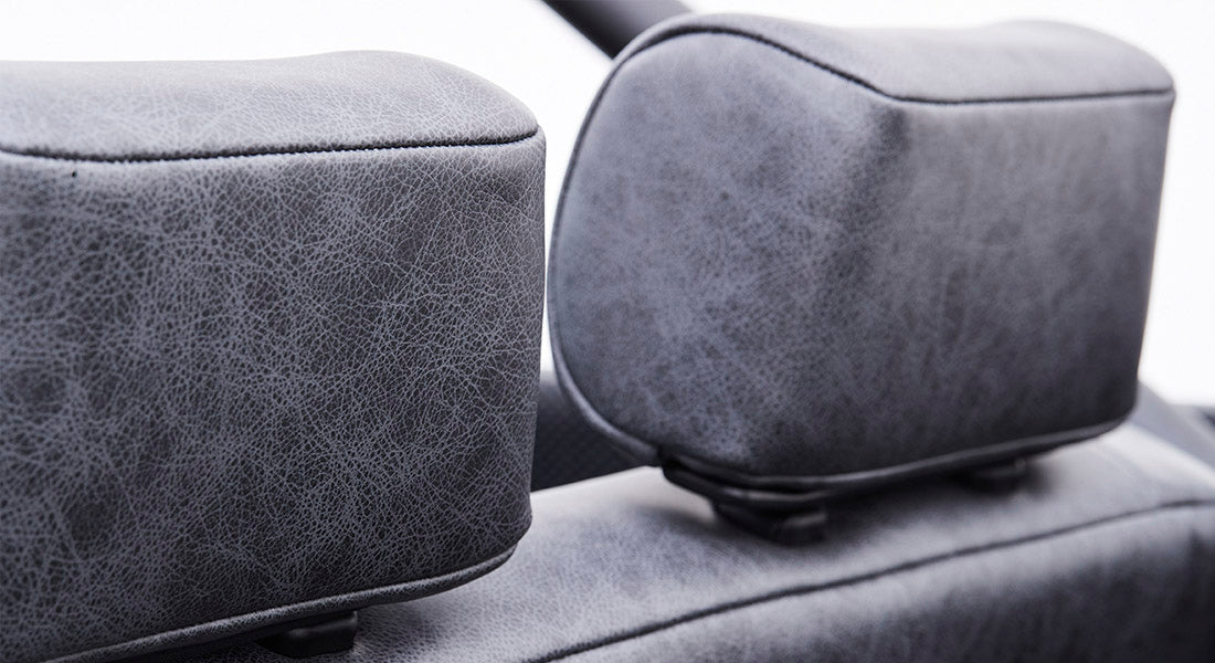 Side view of two gray textured headrests on Classic Ford Bronco seats, focusing on wear details.