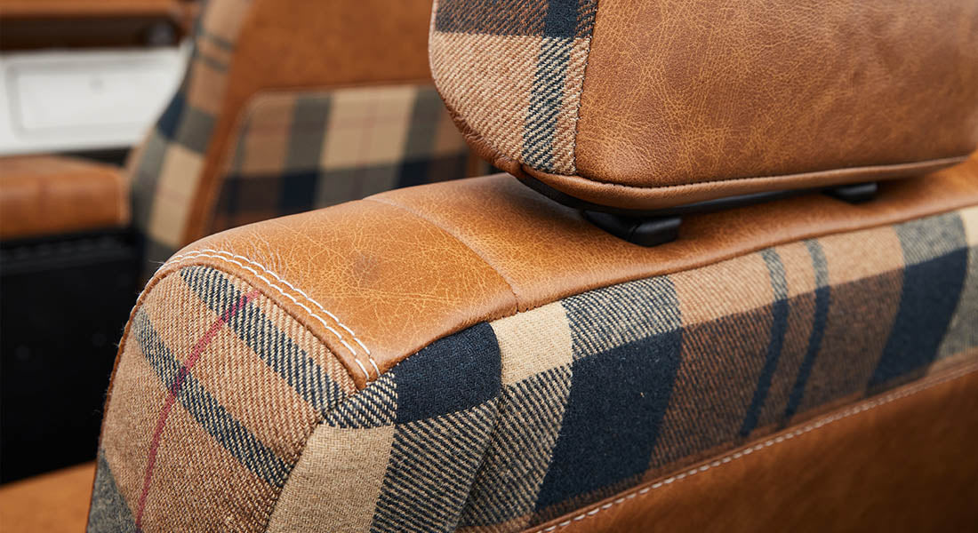Brown leather and plaid fabric upholstery on Classic Ford Bronco seat