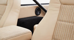 Detail of beige and woven fabric upholstery inside a Classic Ford Bronco.
