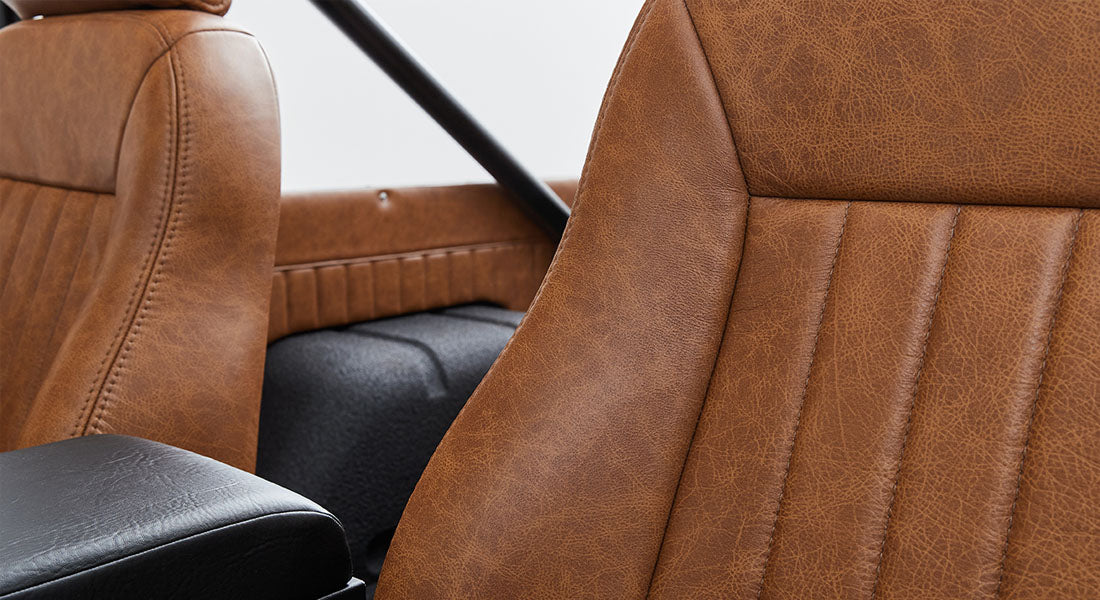 Brown leather seats and interior paneling of a Classic Ford Bronco