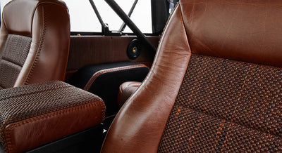 Two-tone brown leather and woven fabric seats inside Classic Ford Bronco