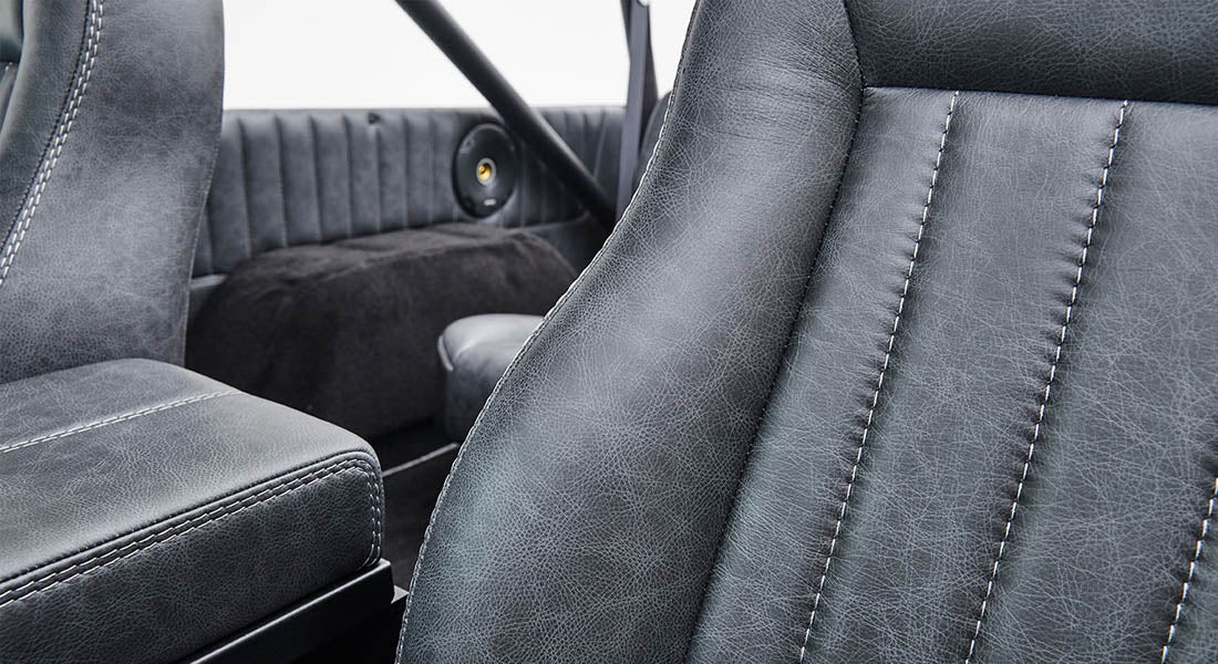 Black leather interior seats with detailed stitching in Classic Ford Bronco