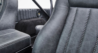 Black leather interior seats with detailed stitching in Classic Ford Bronco