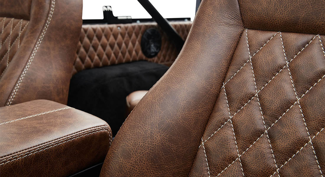 Brown leather interior seat detail with white stitching inside Classic Ford Bronco