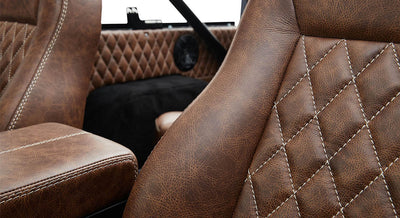 Brown leather interior seat detail with white stitching inside Classic Ford Bronco