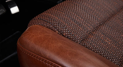 Close-up of woven brown and leather upholstery on Classic Ford Bronco seat corner