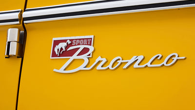 Ford Bronco 1975 in Chrome Yellow with custom Basket Weave Interior and Wimbledon White Wheels