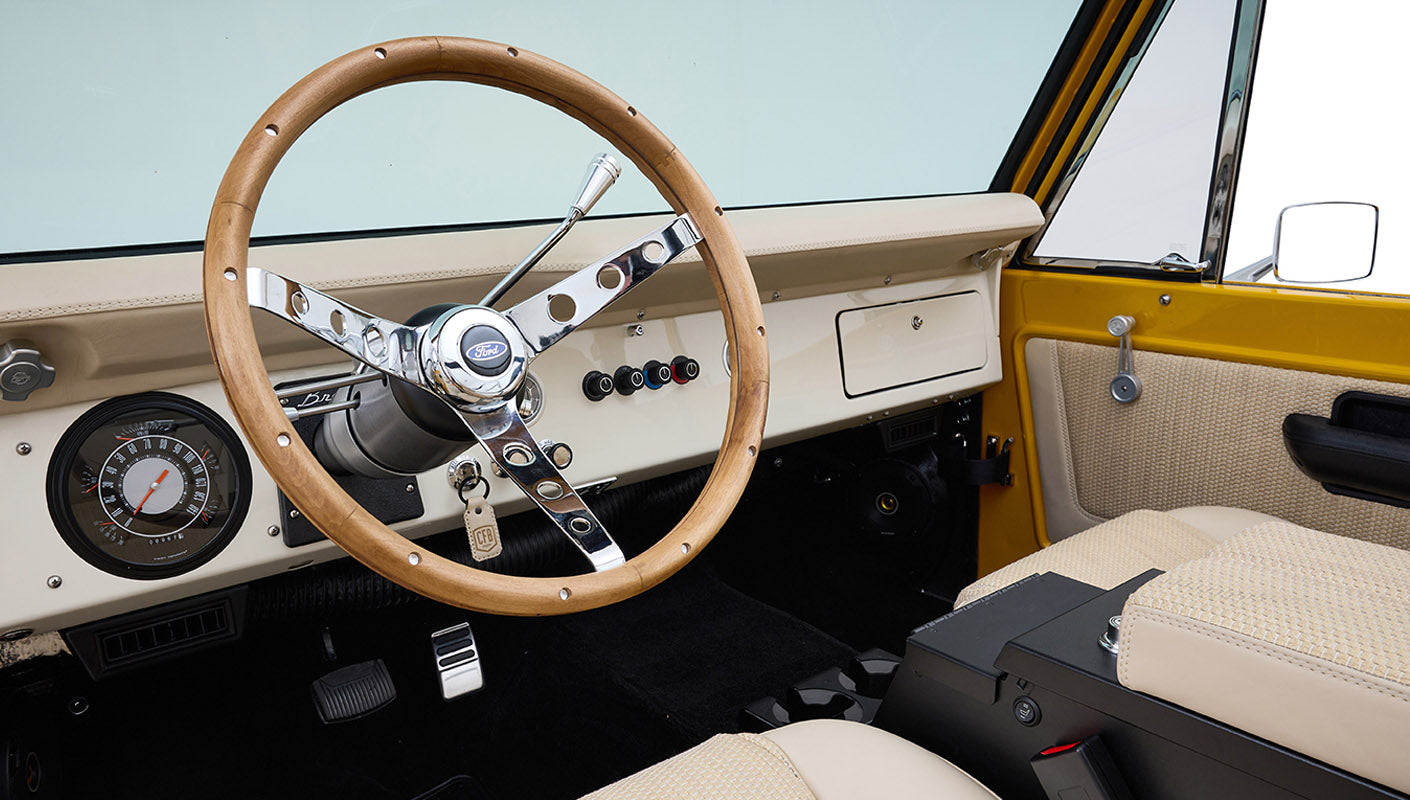 Ford Bronco 1975 in Chrome Yellow with custom Basket Weave Interior and Wimbledon White Wheels
