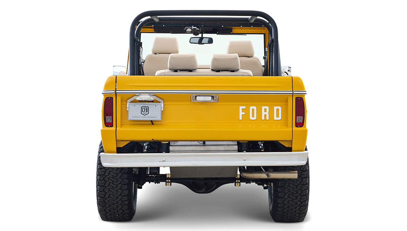 Ford Bronco 1975 in Chrome Yellow with custom Basket Weave Interior and Wimbledon White Wheels