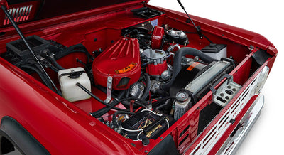 Engine compartment of a red Classic Ford Bronco with hood open