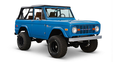 1976 Blue Classic Ford Bronco Coyote Series with black soft top and whiskey leather interior