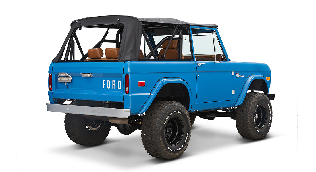 1976 Blue Classic Ford Bronco Coyote Series with black soft top and whiskey leather interior