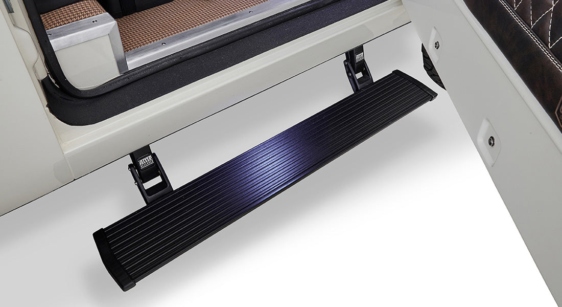 Black power step mounted on vehicle door frame against white background