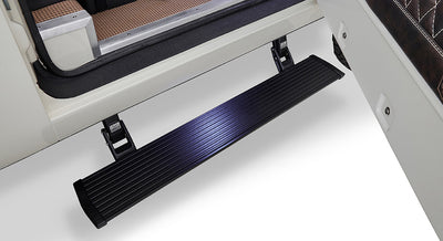 Black power step mounted on vehicle door frame against white background