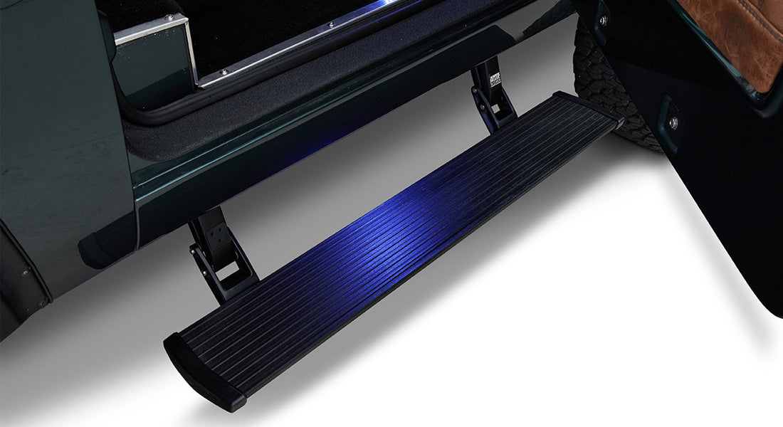 Retracted black power step attached beneath door of Classic Ford Bronco