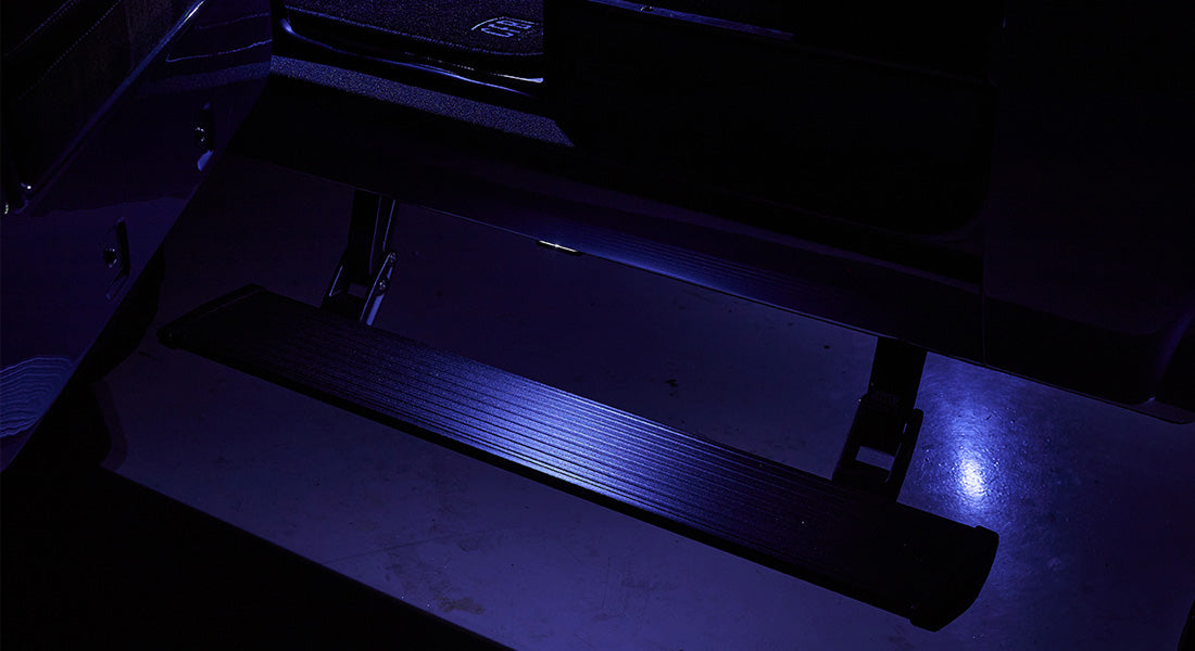 Illuminated black side step with blue light under Classic Ford Bronco door
