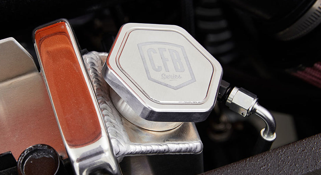 Polished metal radiator cap and hoses inside the engine compartment