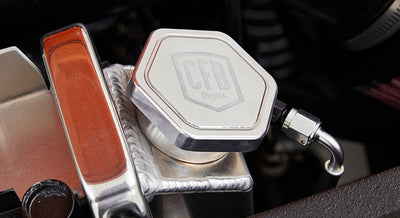 Polished metal radiator cap and hoses inside the engine compartment
