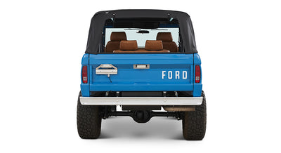 1976 Blue Classic Ford Bronco Coyote Series with black soft top and whiskey leather interior
