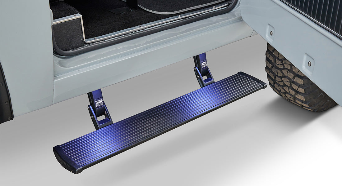 Black running board step extending from the side of a Classic Ford Bronco beneath the open door