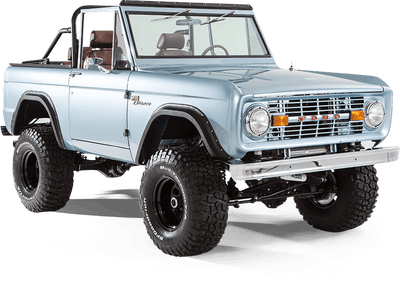 Side view of light blue Classic Ford Bronco with black wheels and lifted suspension