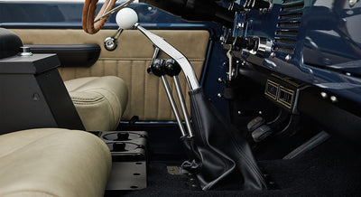 Classic Ford Bronco interior showing gear shifters and tan seats