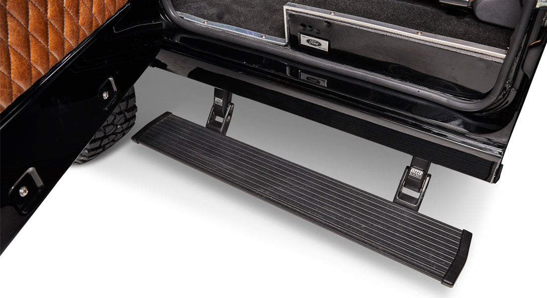 Retractable black sidestep mounted under door frame of Classic Ford Bronco