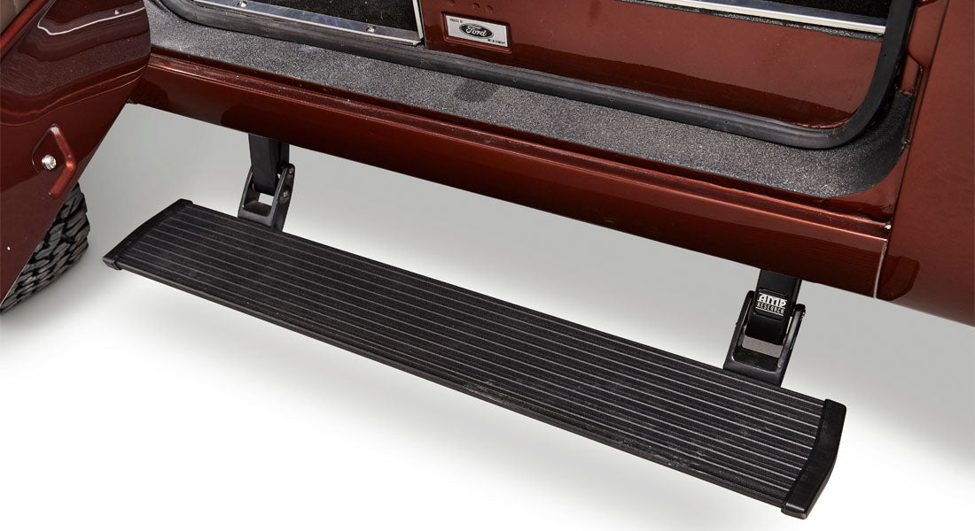 Close-up of Classic Ford Bronco interior showing pedals and part of dashboard with gauges