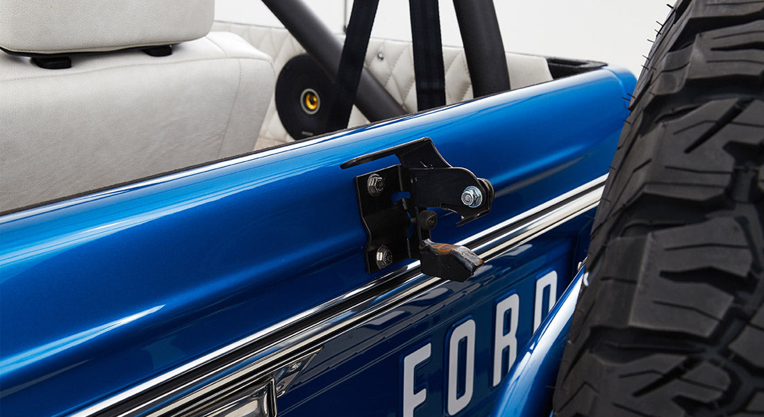 Blue exterior door and rear mounted tire of Classic Ford Bronco