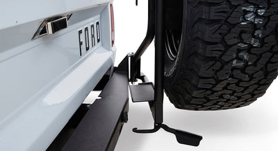 Rear view of Classic Ford Bronco tailgate with spare tire mounted and visible Ford lettering.