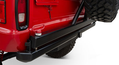 Rear side of a red Classic Ford Bronco with a spare tire and release mechanism