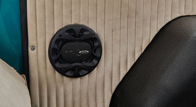 Black speaker mounted on beige interior panel of a Classic Ford Bronco