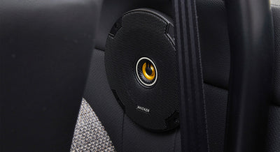 Black classic Ford Bronco speaker with yellow center mounted in rear interior