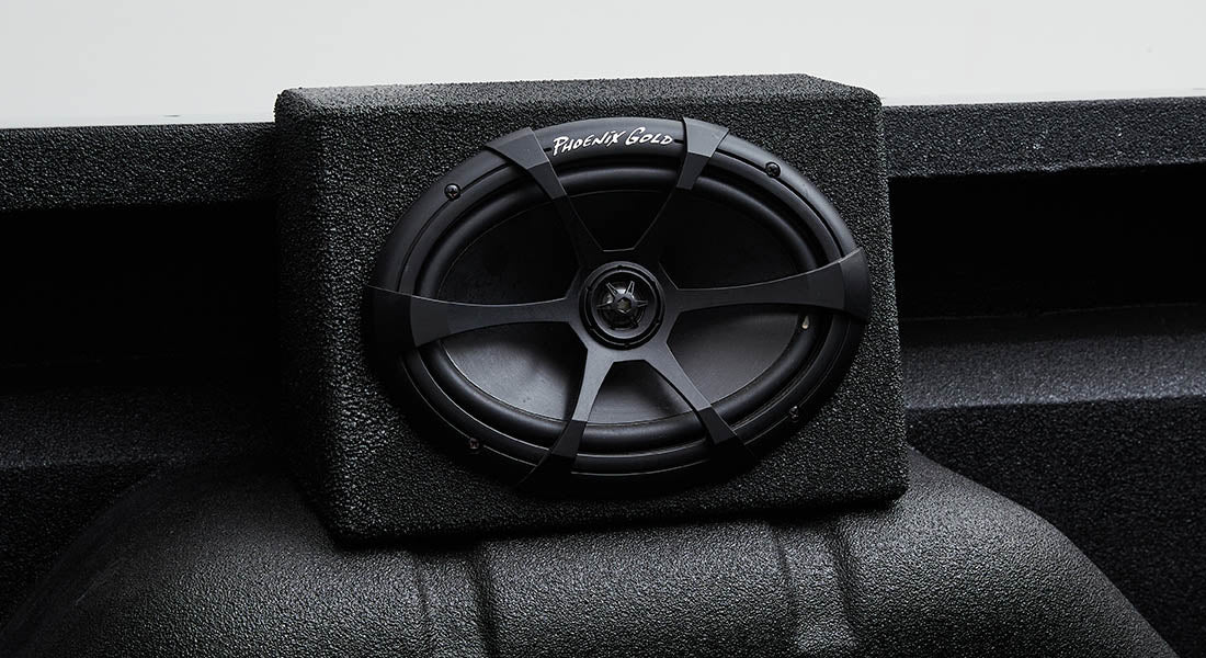 Black Phoenix Gold speaker mounted on black textured enclosure inside Classic Ford Bronco
