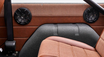 Interior side panel with black speakers and brown upholstery in Classic Ford Bronco