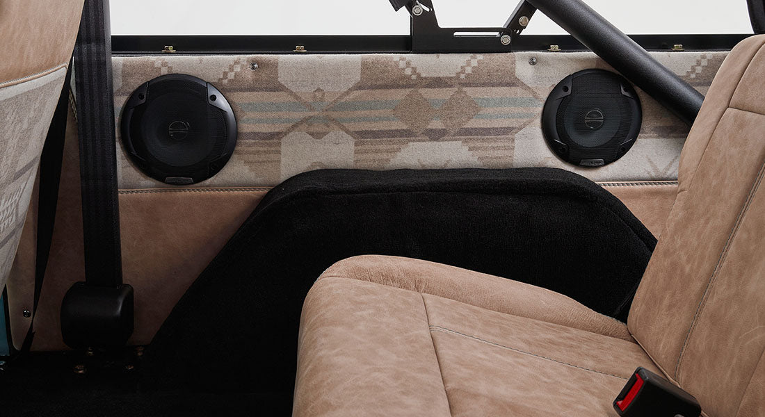 Pair of Classic Ford Bronco interior speakers mounted on rear side panel with patterned fabric