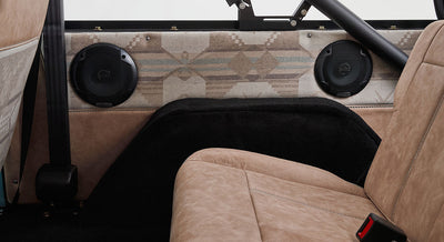 Pair of Classic Ford Bronco interior speakers mounted on rear side panel with patterned fabric